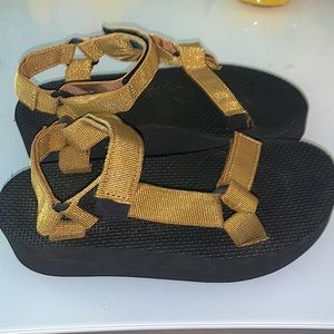 Black and gold Teva platform